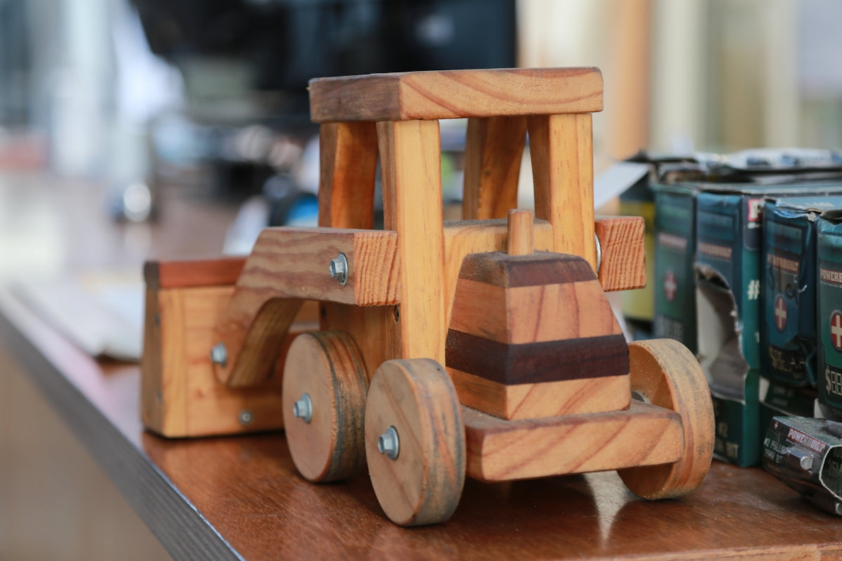 a wooden toy train sitting on top of a wooden table