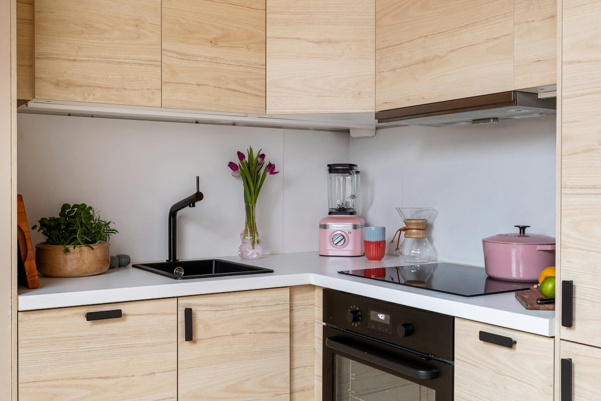 A kitchen with wooden cabinets and white counter tops