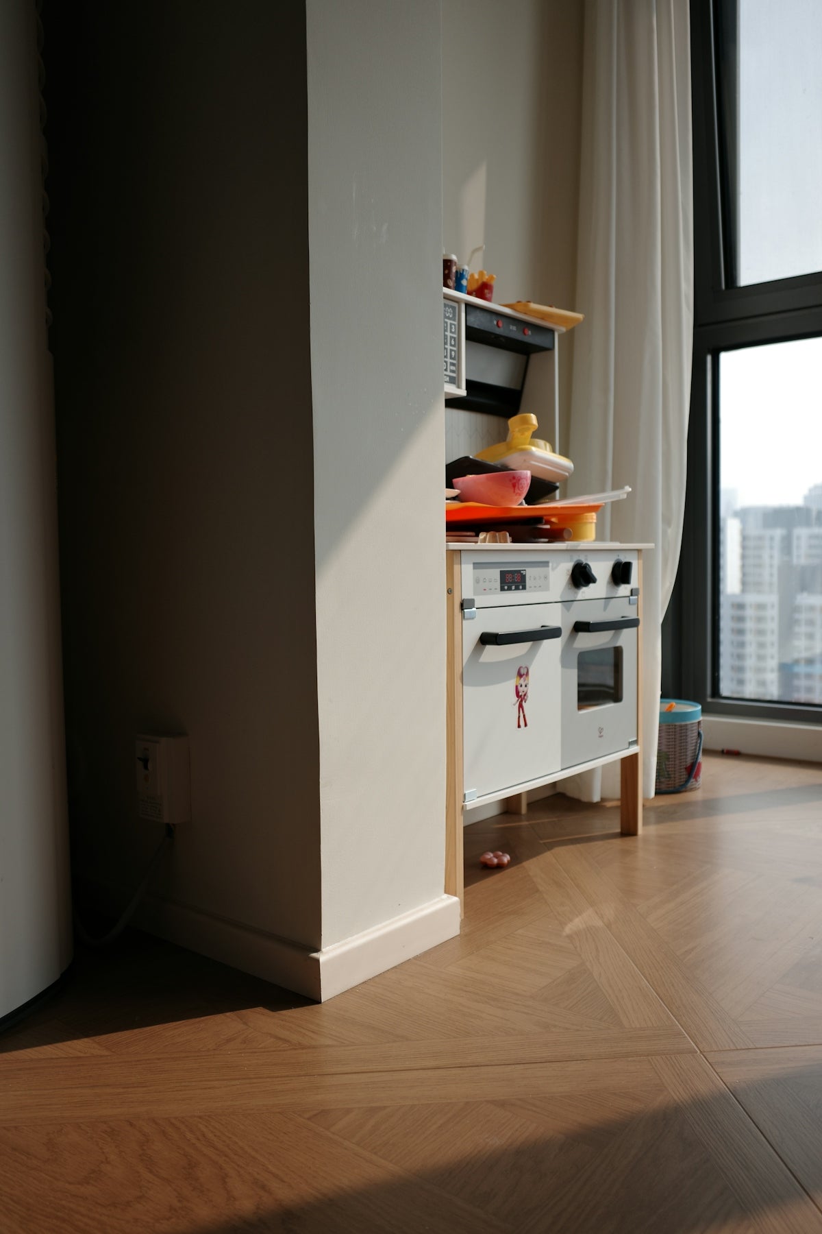 A child's play kitchen near a window