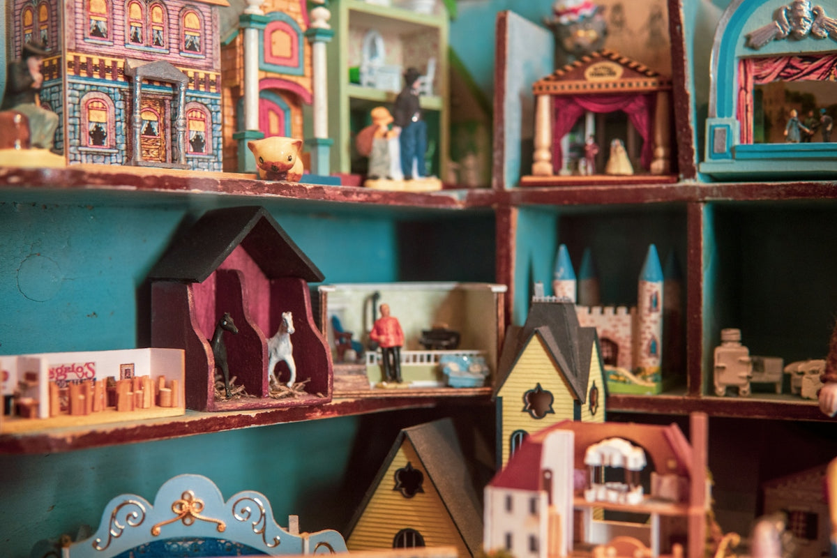 brown wooden house miniature on brown wooden shelf