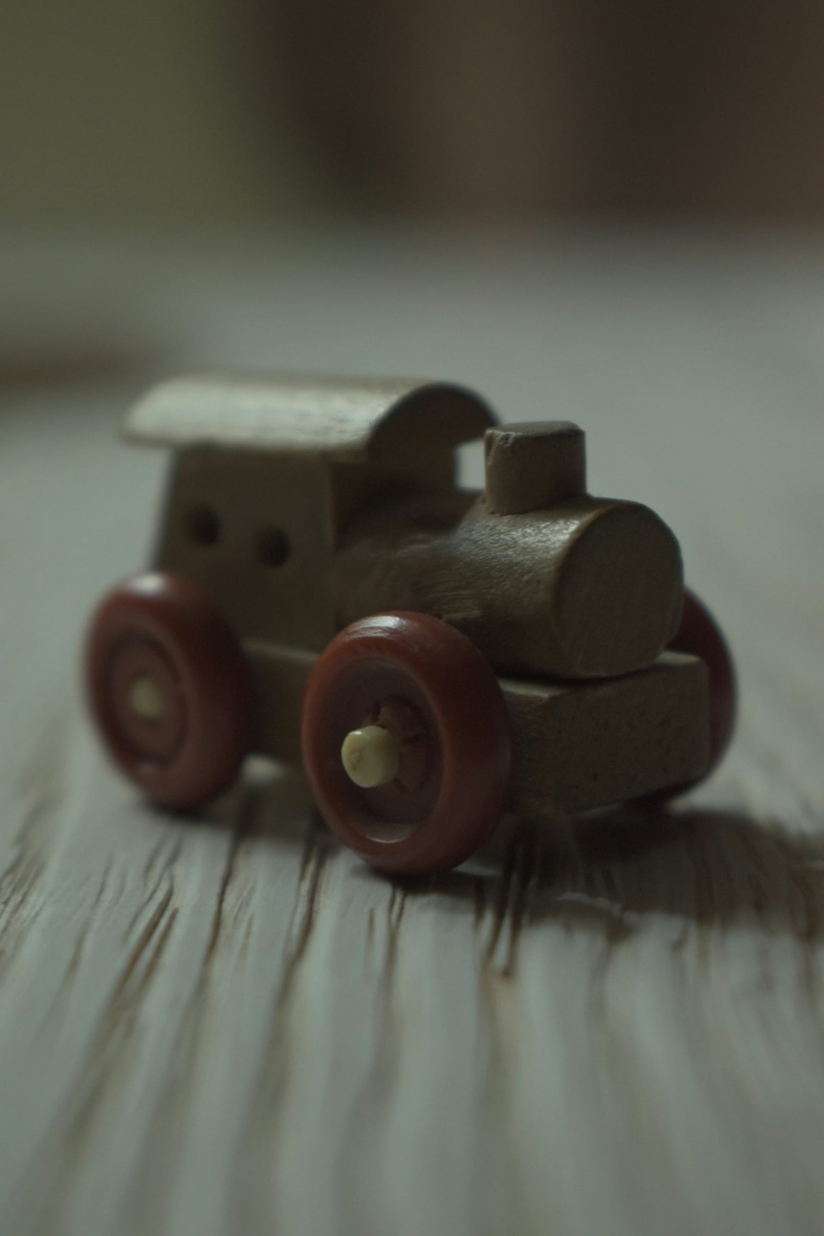a wooden toy car sitting on top of a wooden table
