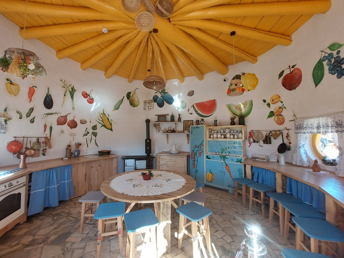 a kitchen area with a table and chairs