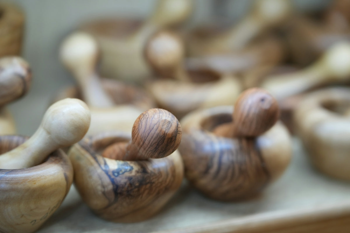Wooden mortars and pestles displayed for sale